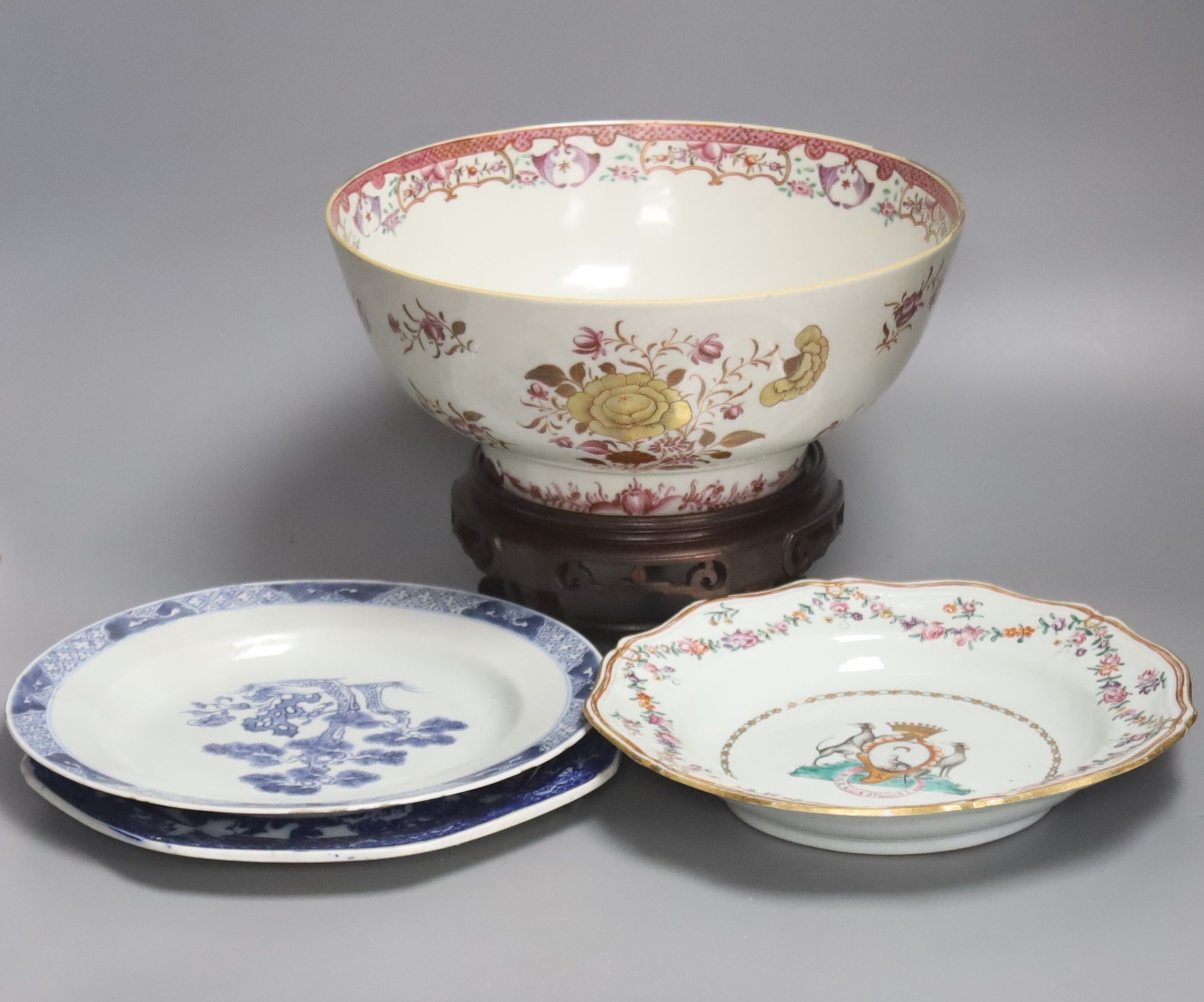 A Chinese export armorial soup plate, a large 18th century Chinese export porcelain footed punch bowl on stand, A Chinese blue and white plates and a pearlware plate